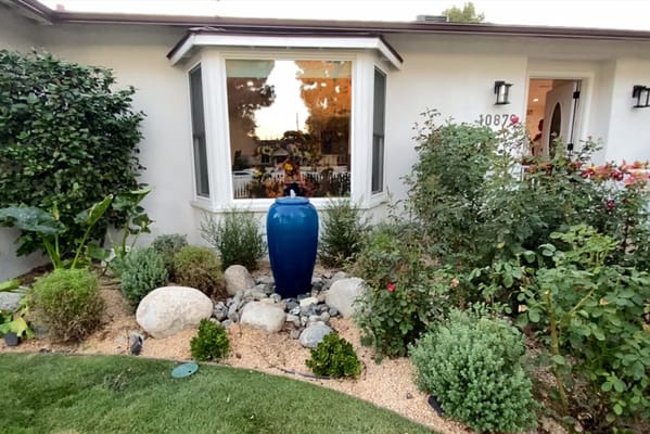 Garden area with blue vase and plants