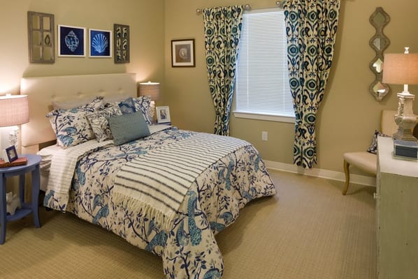 A tastefully decorated resident room with floral bedding