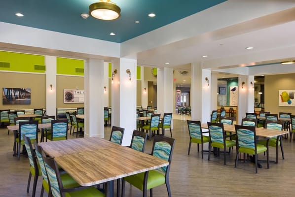 Dining area with tables and chairs in a bright interior