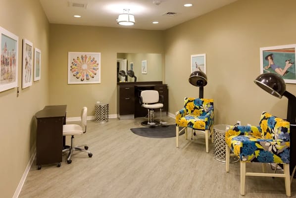 Hair salon with colorful chairs and artwork
