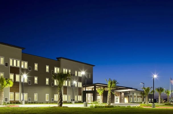 Exterior view of a senior living facility at twilight