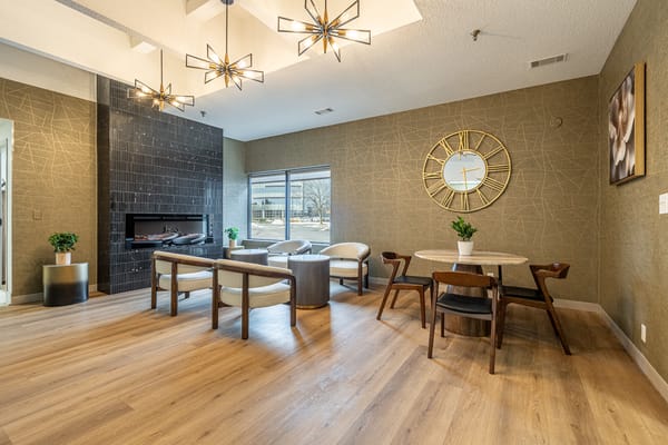 Bright common area with seating and a clock