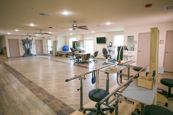 Interior view of a therapy gym with exercise equipment