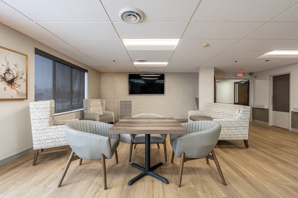 Bright common area with seating and a table