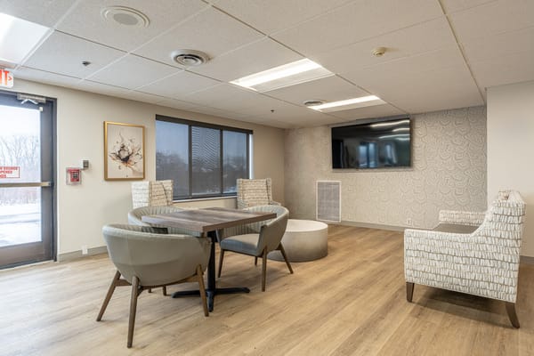 Bright common area with seating and a TV