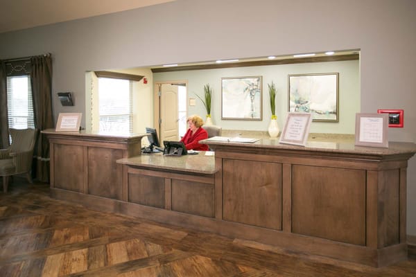 Reception area with staff member seated at the desk