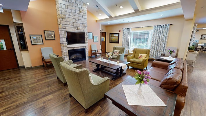 Common area with seating and decor in a senior living facility