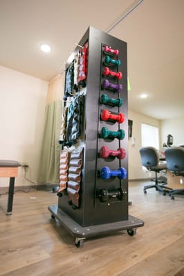 A rack of colorful dumbbells in a fitness area