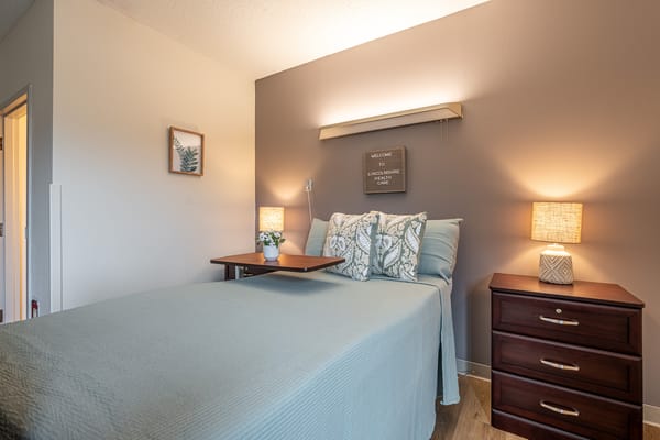 Cozy resident room with bed and bedside table