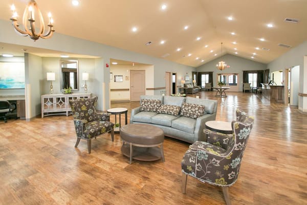 Bright common area with seating and wood flooring