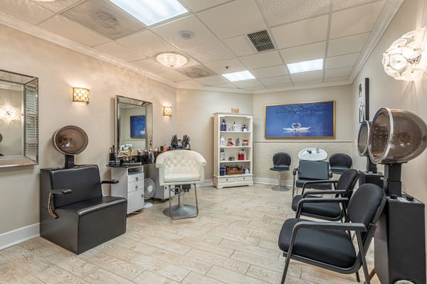 Interior of a salon with styling stations and chairs