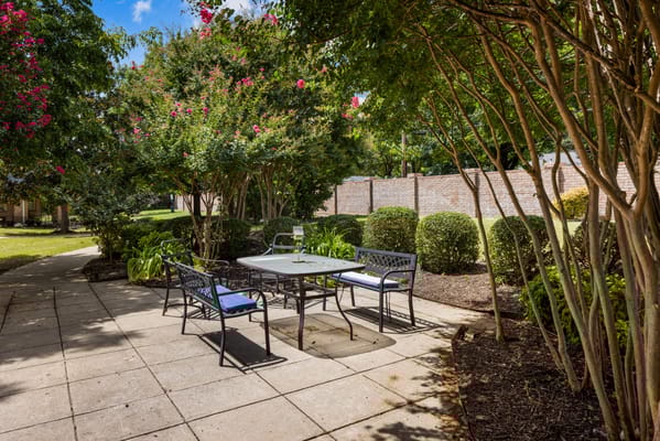 Outdoor patio area with seating and lush greenery
