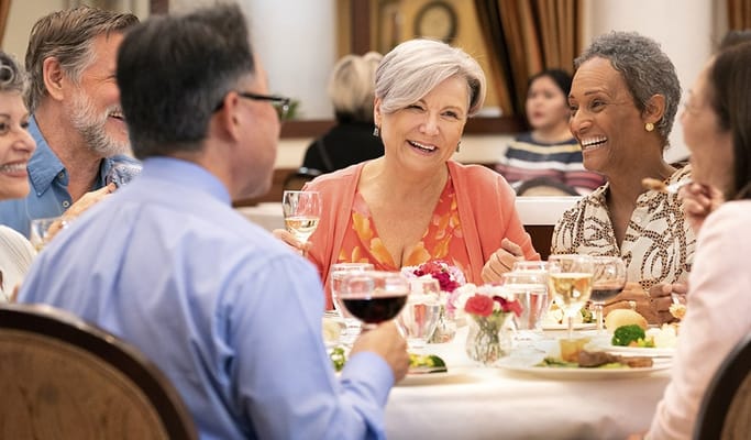 Residents enjoying a meal together in the dining room
