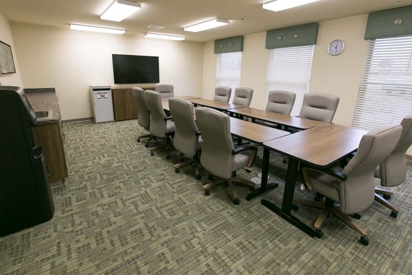 A conference room with a long table and chairs