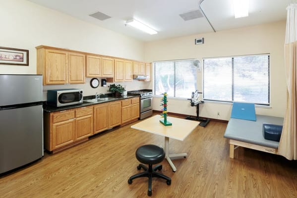 Common kitchen area with appliances and a dining table