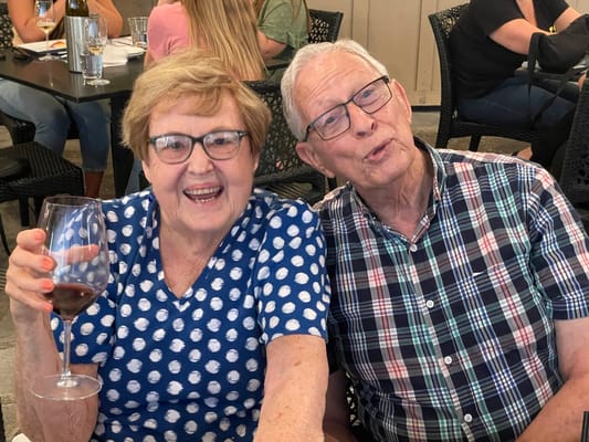 Couple enjoying a glass of wine at a social event