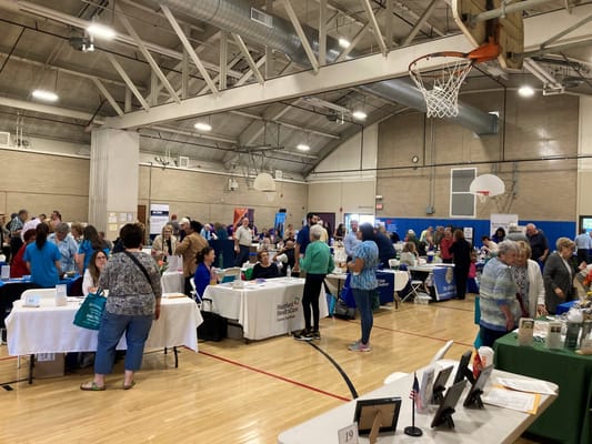 A busy event with vendors and residents interacting