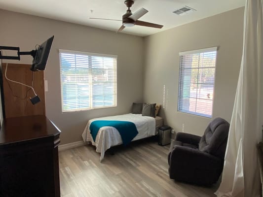 A cozy resident room with natural light and amenities