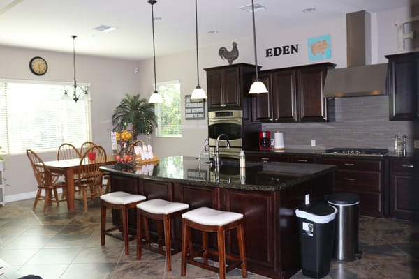 Bright kitchen featuring dark wood cabinetry and dining area