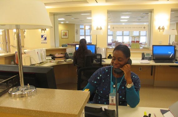 Staff member at reception desk speaking on the phone