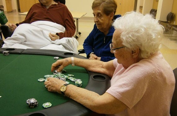 Residents playing poker in an activity room