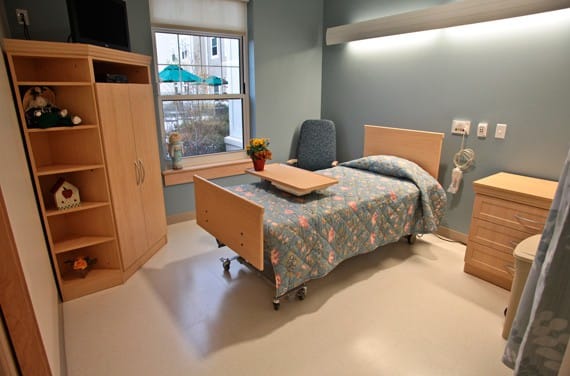 Private resident room with a hospital bed and bright decor