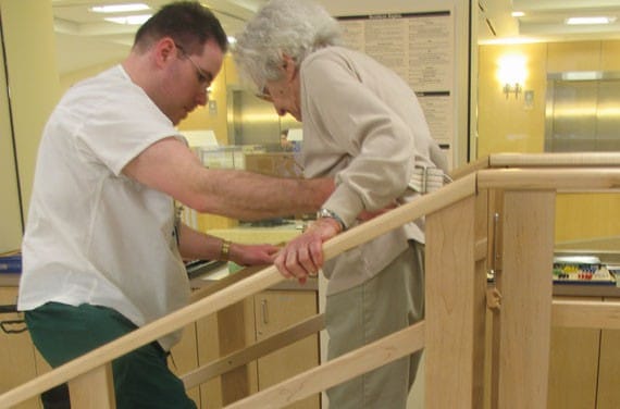 Staff assisting a resident with mobility support