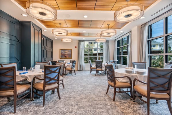 Bright dining room with modern decor and large windows
