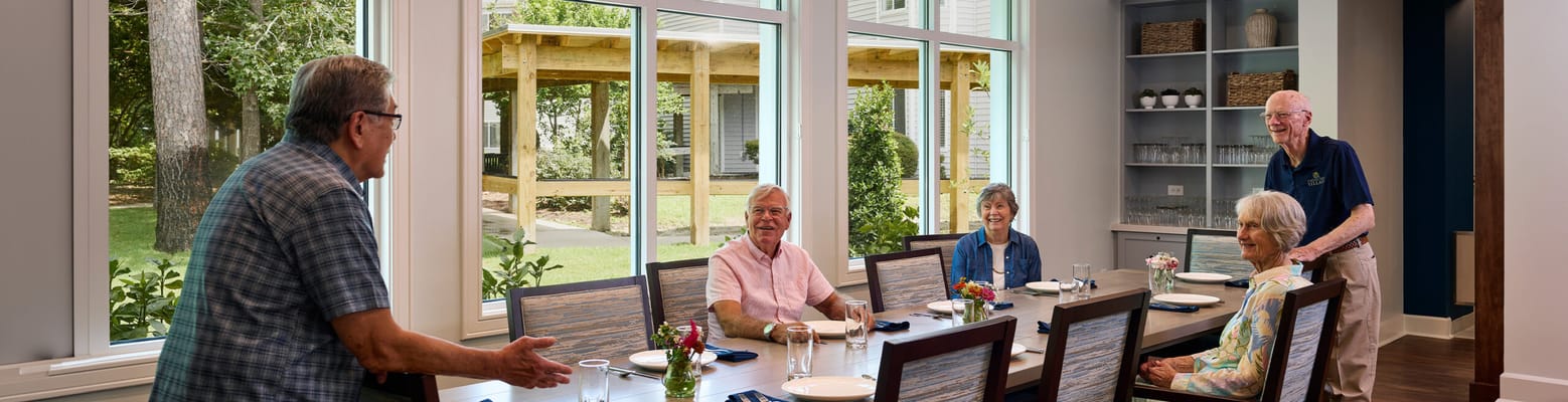 Residents enjoying a meal in a bright dining area