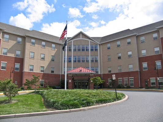 Exterior view of a nursing home with an American flag
