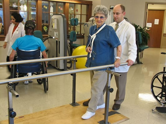 A resident receiving assistance during therapy.
