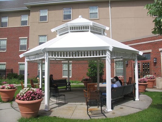 Outdoor gazebo area with residents relaxing
