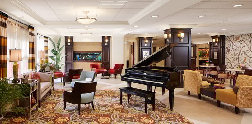 Interior view of a common area with a piano and seating