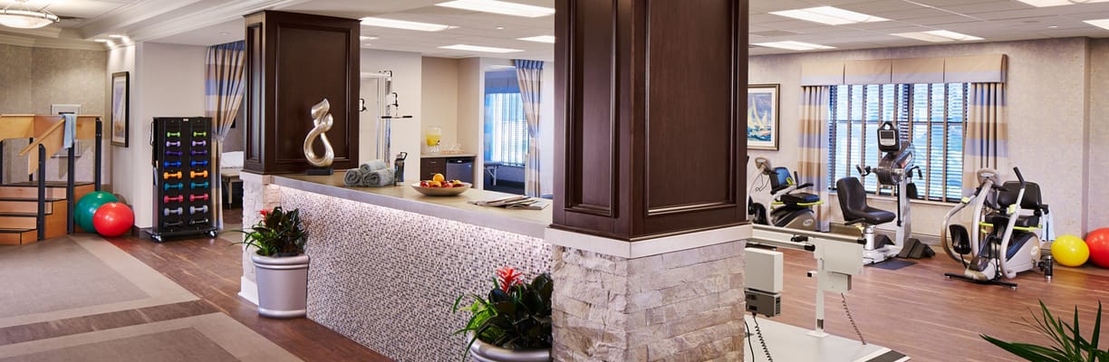 Well-equipped fitness room with exercise equipment and decor