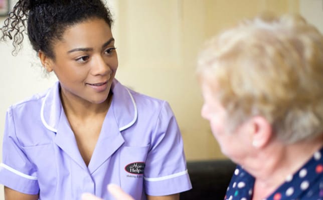 Caregiver engaging with a resident in an indoor setting