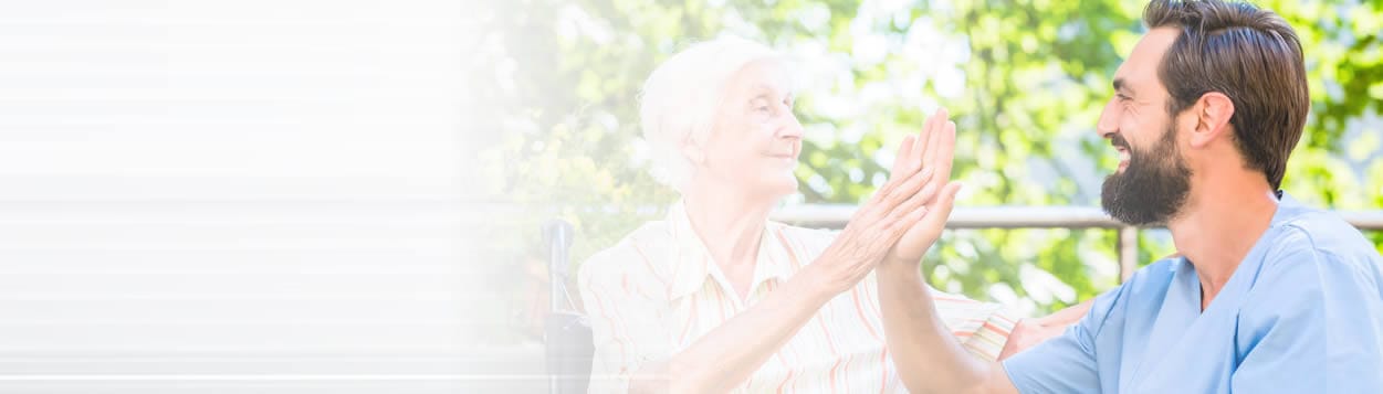 Caregiver interacting with a senior in an outdoor setting