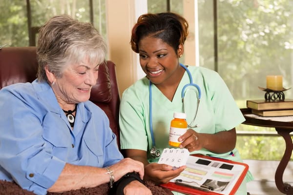 Caregiver assisting a resident with medication