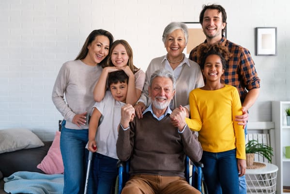 A family gathering with a senior man in a wheelchair