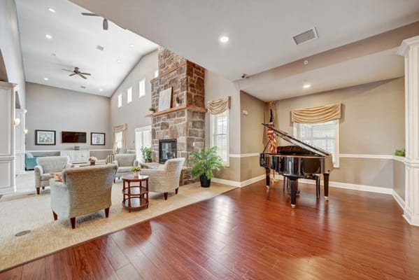 Bright common area with a piano and seating