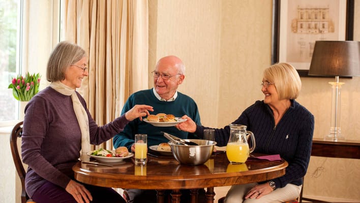 Residents enjoying a meal together in a dining area