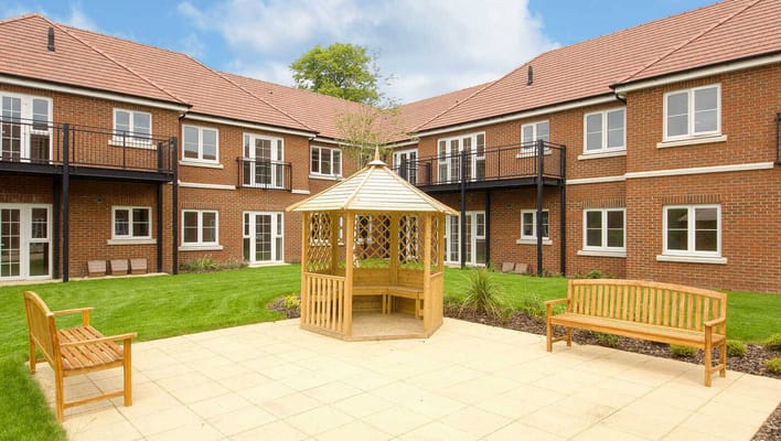A serene garden area with gazebo and benches