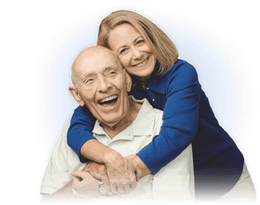 Senior man and caregiver smiling together