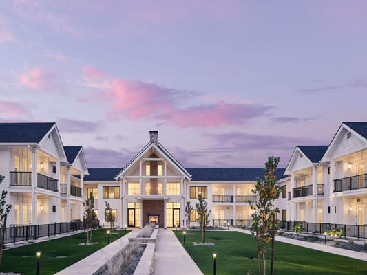 Exterior view of American Groves Senior Living at dusk