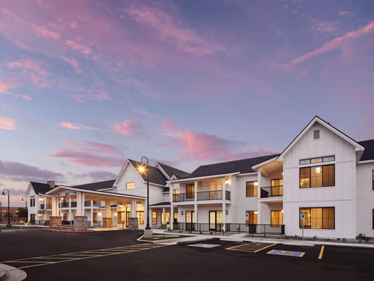 Exterior view of American Groves Senior Living at sunset