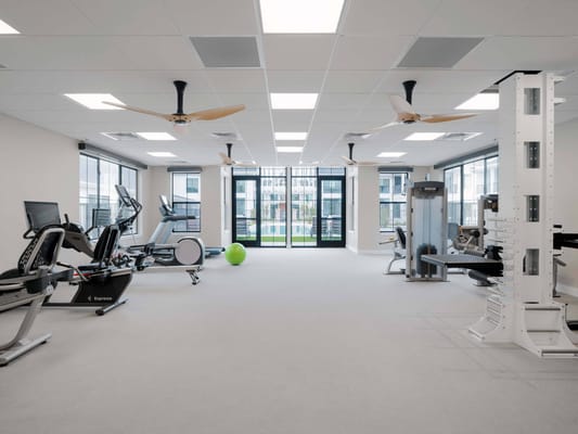 Interior view of a well-lit exercise room with equipment