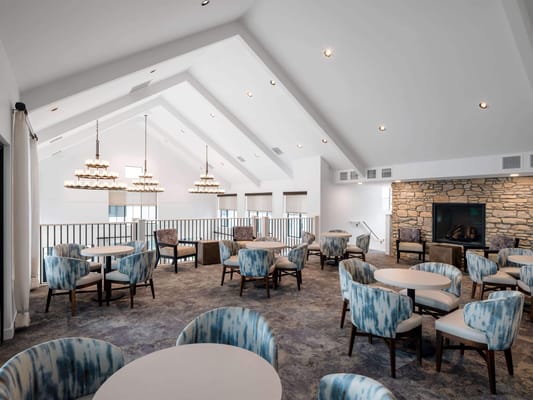 Bright common area with seating and a fireplace