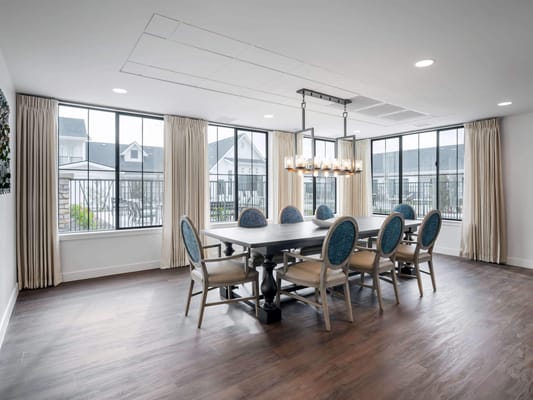Bright dining room with communal table and large windows