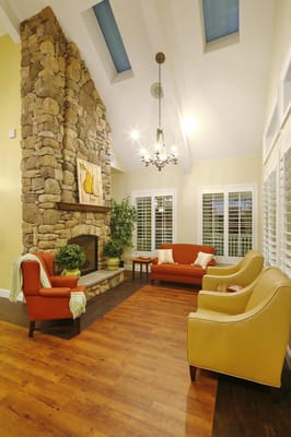 Cozy common area with stone fireplace and seating