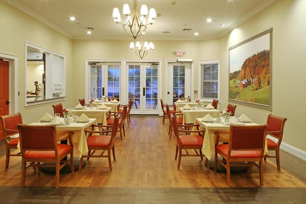 Bright dining room with tables set for meals