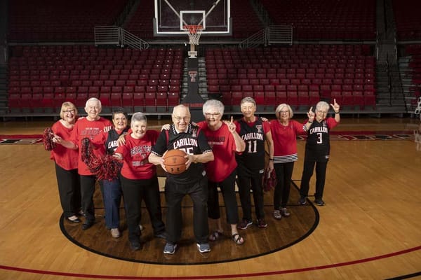 Group of seniors in jerseys on a basketball court